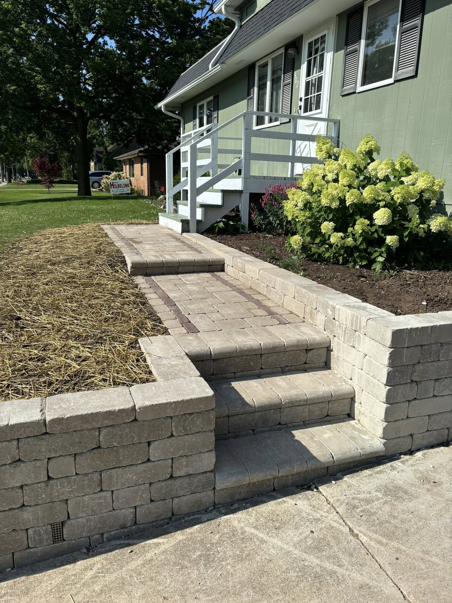Featured curved block retaining wall project by Beyond Landscaping in Sheboygan Falls, WI